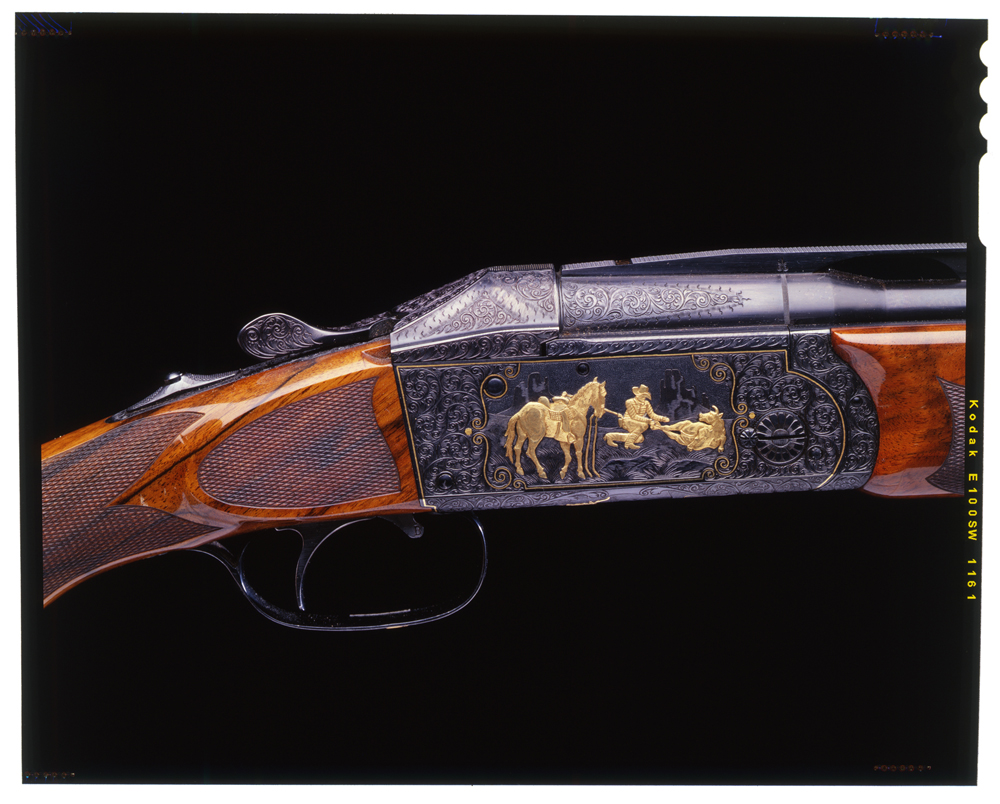 H. Kreighoff, Ulm Germany - Cased Keighoff Model 32 shotgun. Detail of cowboy scene rendered in gold. Engraving by Walter Kolouch.